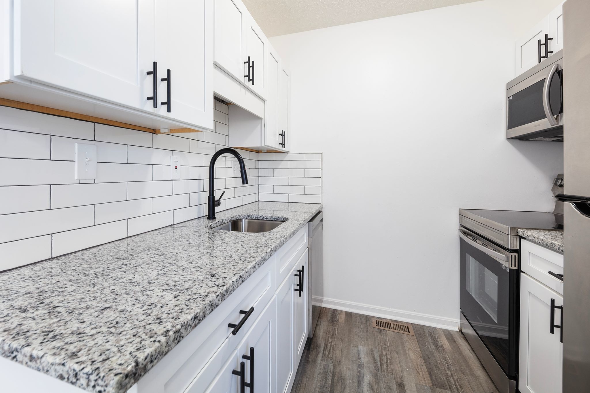 Renovated kitchen with granite countertops at Fairfield Square Apartments in Fairfield, Ohio